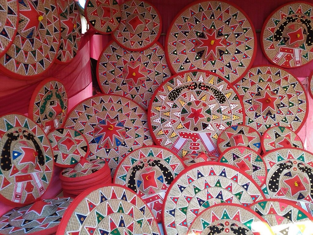 Dozens of decorated jaapis, the conical Assamese hats, hanging in a market stall